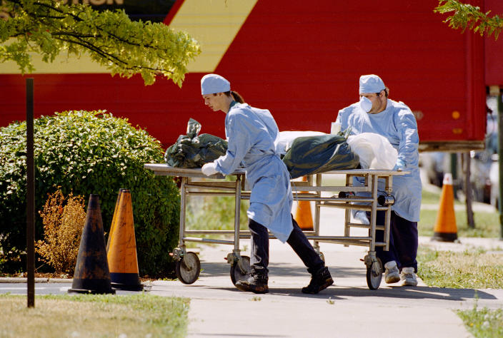 FILE - Workers at the Cook County morgue in Chicago wheel a body to refrigerator trucks on Tuesday, July 18, 1995. Several trucks were parked near the morgue to handle an overflow of bodies, most believed to be victims of the heat wave. As heat waves fueled by climate change arrive earlier, grow more intense and last longer, people over 60 who are more vulnerable to high temperatures are increasingly at risk of dying from heat-related causes. (AP Photo/Mike Fisher,File)