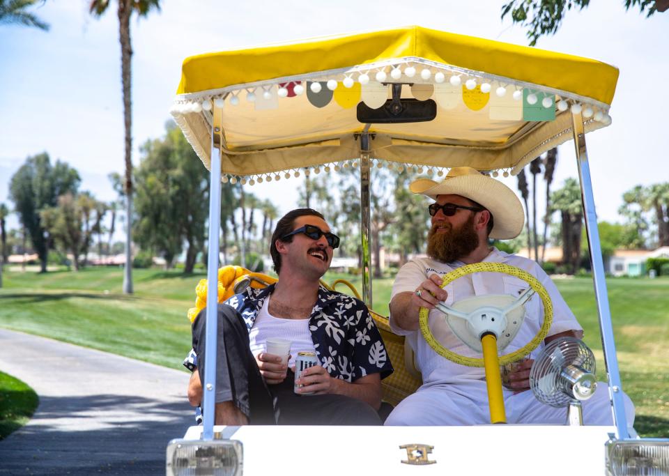 Kai Franz (left) of Dana Point and Craig Dunlap of San Juan Capistrano share a laugh in their vintage cart while roaming the course during the 16th annual Nation Desert Classic at Indian Wells Country Club in Indian Wells, Calif., Saturday, May 4, 2024.