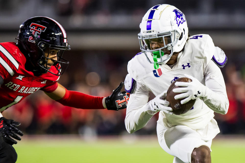 LUBBOCK, TEXAS - AUGUST 31: J.J. Henry #4 of the Abilene Christian Wildcats runs with the ball against A.J. McCarty #1 of the Texas Tech Red Raiders during the second half of the game at Jones AT&T Stadium on August 31, 2024 in Lubbock, Texas.  (Photo by John E. Moore III/Getty Images)