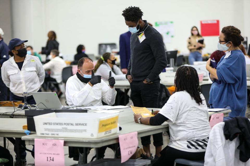 Questions are answered by Detroit Elections employees as absentee ballots are processed by election officials in the Detroit Elections Department Absentee Ballot counting room at the then-TCF Center in Downtown Detroit on Wednesday, Nov. 4, 2020.