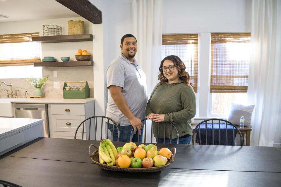 As seen on HGTV’s Home Town Kickstart with hosts Lyndsay Lamb and Leslie Davis, Chris and Mishayla Garrett pose for a portrait inside their renovated house in Winslow, AZ.