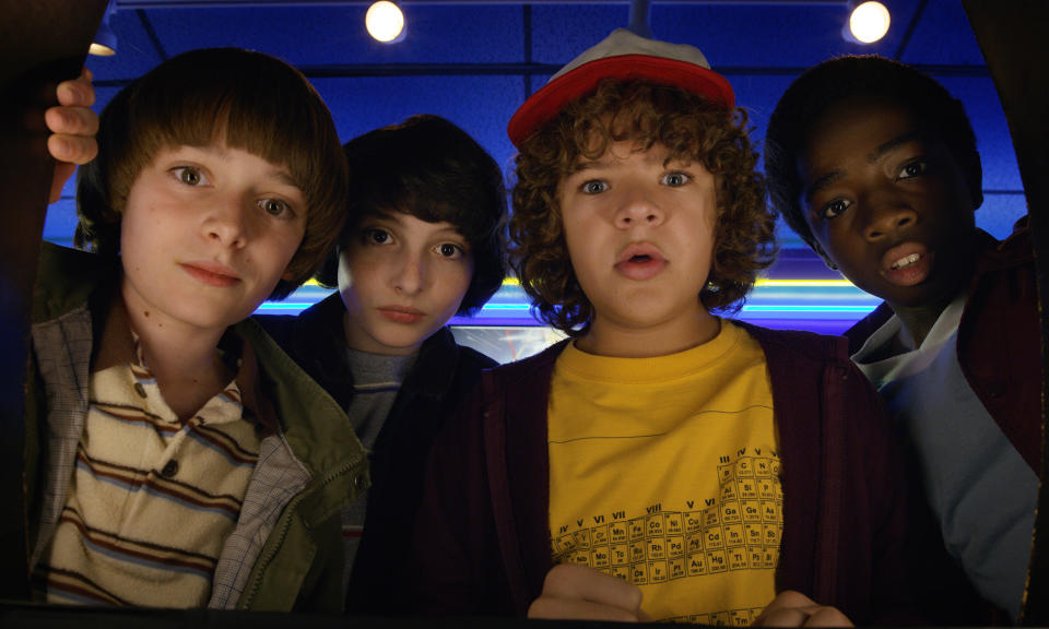 This image released by Netflix shows Noah Schnapp, from left, Finn Wolfhard, Gaten Matarazzo and Caleb Mclaughlin in a scene from "Stranger Things." It took less than a decade for leader Netflix to skyrocket from about 12 million U.S. subscribers at the decade's start to 60 million this year and 158 million worldwide. (Netflix via AP)
