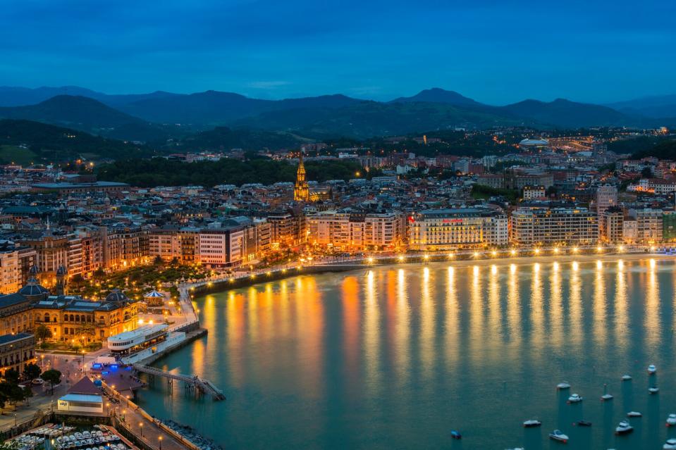 City skyline by night with Bahia de la Concha, Donostia San Sebastian, Gipuzkoa, Basque Country, Spain