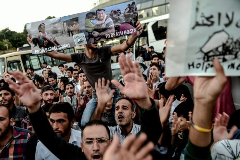 Migrants and refugees demonstrate at Istanbul's Esenler Bus Terminal as they wait for buses to the Turkish-Greek border on September 18, 2015