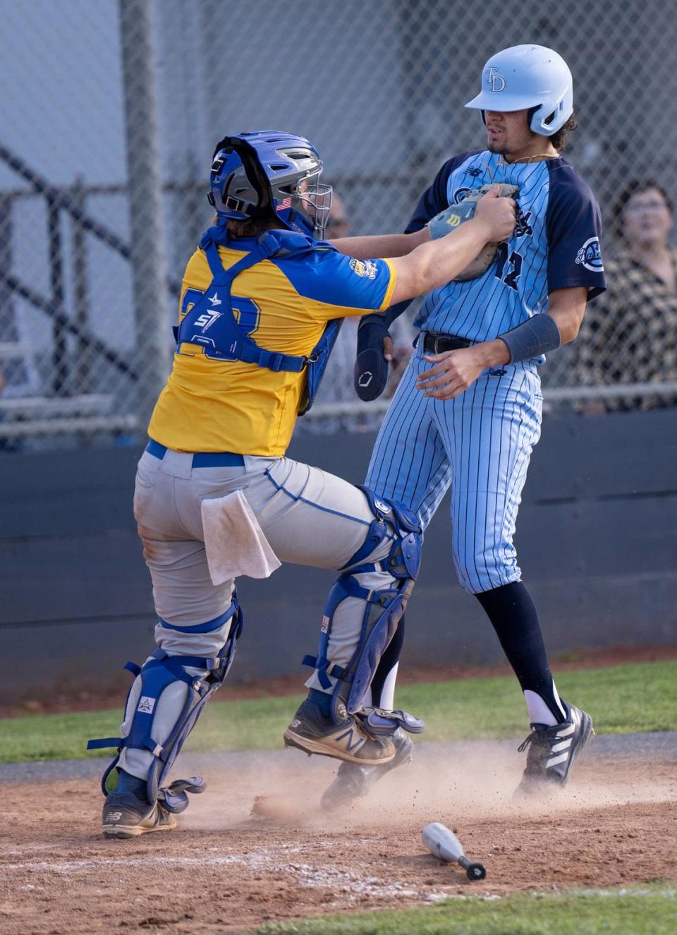 Downey runner Jaxen Rowland is tagged out at the plate by Turlock catcher Owen Miller to end the game at Downey High School in Modesto, Calif., Friday, April 12, 2024. Turlock won the game 3-2.