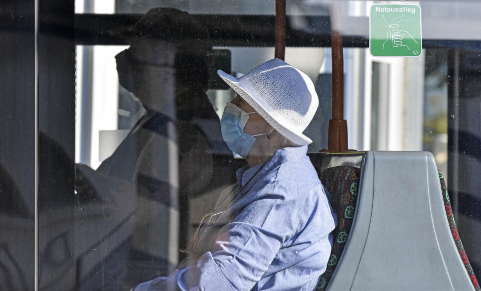 Passengers wear face masks at a tram in Gelsenkirchen, Germany, Wednesday, Aug. 12, 2020. To avoid the outspread of the coronavirus wearing a mask is mandatory at all public transport. (AP Photo/Martin Meissner)