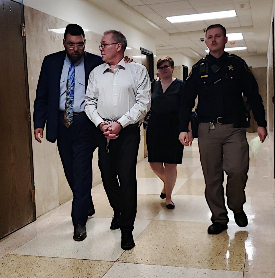 Thomas white, center, speaks with his attorney Afshin Zand  as he is led out of the 140th District Court where he pleaded guilty to two counts of aggravated sexual assault of a child in exchange for a 50-year prison sentence.