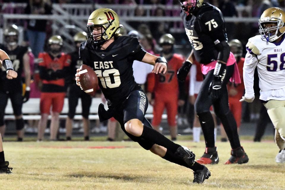 Bullitt East's Travis Egan (10) runs from the Male defense during action of their game, Friday, Oct. 21 2022 in Mt. Washington Ky.