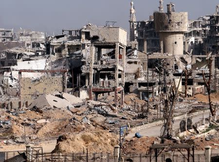 FILE PHOTO: A view of damaged buildings in Jobar as seen from Harasta highway, in Damascus, Syria March 27, 2018. REUTERS/Omar Sanadiki/File Photo