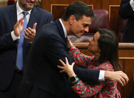 Spain's new Prime Minister and Socialist party (PSOE) leader Pedro Sanchez embraces party member Margarita Robles after a motion of no confidence vote at parliament in Madrid, Spain, June 1, 2018. REUTERS/Sergio Perez