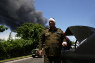 A member of the Interior Ministry injured while trying to help in rescue efforts returns to help, near the Matanzas Supertanker Base, where firefighters work to quell a blaze which began during a thunderstorm the night before, in Matazanas, Cuba, Saturday, Aug. 6, 2022. The fire at an oil storage facility raged uncontrolled Saturday, where four explosions and flames injured nearly 80 people and left over a dozen firefighters missing, Cuban authorities said. (AP Photo/Ramon Espinosa)