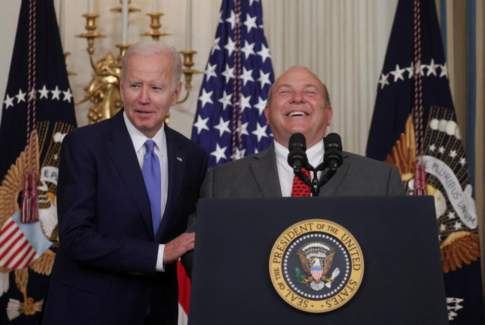 U.S. President Joe Biden speaks as Vincent “Zippy” Duvall, President of the American Farm Bureau Federation laughs, as they attend the signing into law the Ocean Shipping Reform Act of 2022, which will level the playing field for American exporters and importers, including farmers, and reduce costs for American consumers by lowering the cost of ocean shipping, at the White House in Washington, U.S., June 16, 2022. REUTERS/Evelyn Hockstein