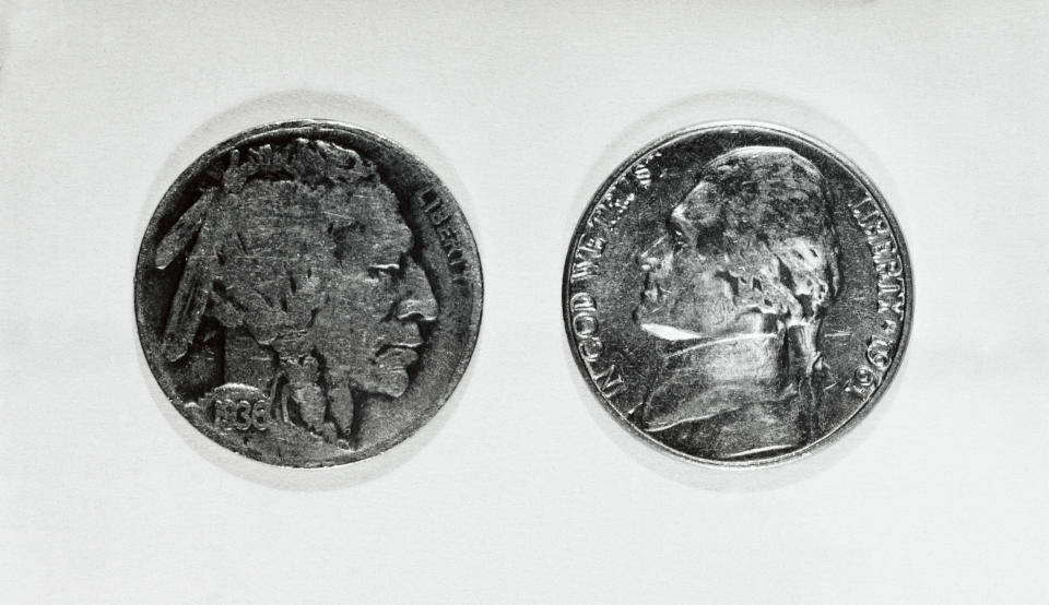 One coin displays the profile of a Native American, labeled "LIBERTY," dated 1936. The other shows Thomas Jefferson, labeled "IN GOD WE TRUST LIBERTY 1964."