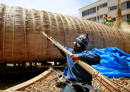 Ruben Limachi, an Aymara builder, works on the 'Viracocha III', a boat made only from the totora reed, as it is being prepared to cross the Pacific from Chile to Australia on an expected six-month journey, in La Paz, Bolivia, October 19, 2016. REUTERS/David Mercado