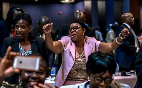 MPs danced and started singing - Credit: JEKESAI NJIKIZANA/AFP