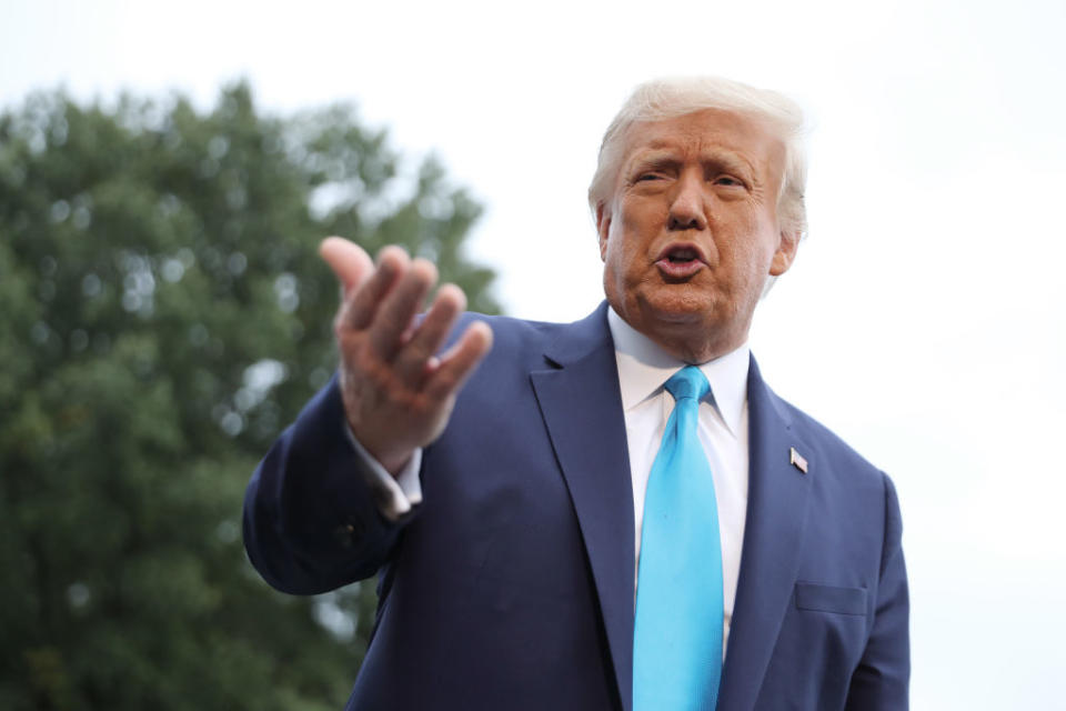 US President Donald Trump speaks to journalists as he departs the White House.