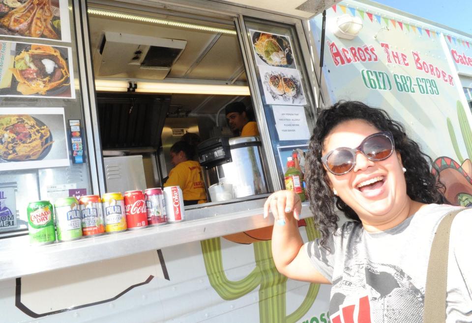 Ana Barbosa waits for nachos from South of the Border during a food truck festival held at the Westgate Mall in Brockton on Oct. 6, 2018. (Marc Vasconcellos/The Enterprise)