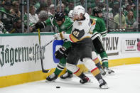 Dallas Stars left wing Jamie Benn (14) and Vegas Golden Knights center Brett Howden (21) compete for control of te puck in the first period of Game 6 of the NHL hockey Stanley Cup Western Conference finals, Monday, May 29, 2023, in Dallas. (AP Photo/Tony Gutierrez)