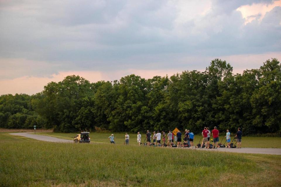 Members of the Wilmore Lawnmower Brigade practice their precision maneuvers in Wilmore, Ky., on Thursday, June 30, 2022.