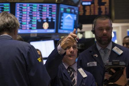 A trader gives a thumbs up while he works on the floor of the New York Stock Exchange February 3, 2014. REUTERS/Brendan McDermid