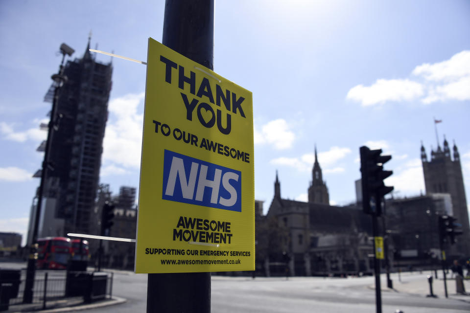 A message in support to the NHS is seen in Westminster, during to the Coronavirus outbreak, in London, Tuesday, April 14, 2020. The new coronavirus causes mild or moderate symptoms for most people, but for some, especially older adults and people with existing health problems, it can cause more severe illness or death.(AP Photo/Alberto Pezzali)