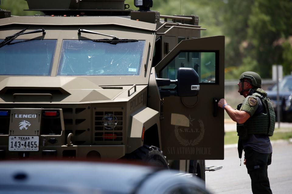 Law enforcement personnel stand next to an armored vehicle outside Robb Elementary School following a shooting, Tuesday, May 24, 2022, in Uvalde, Texas.