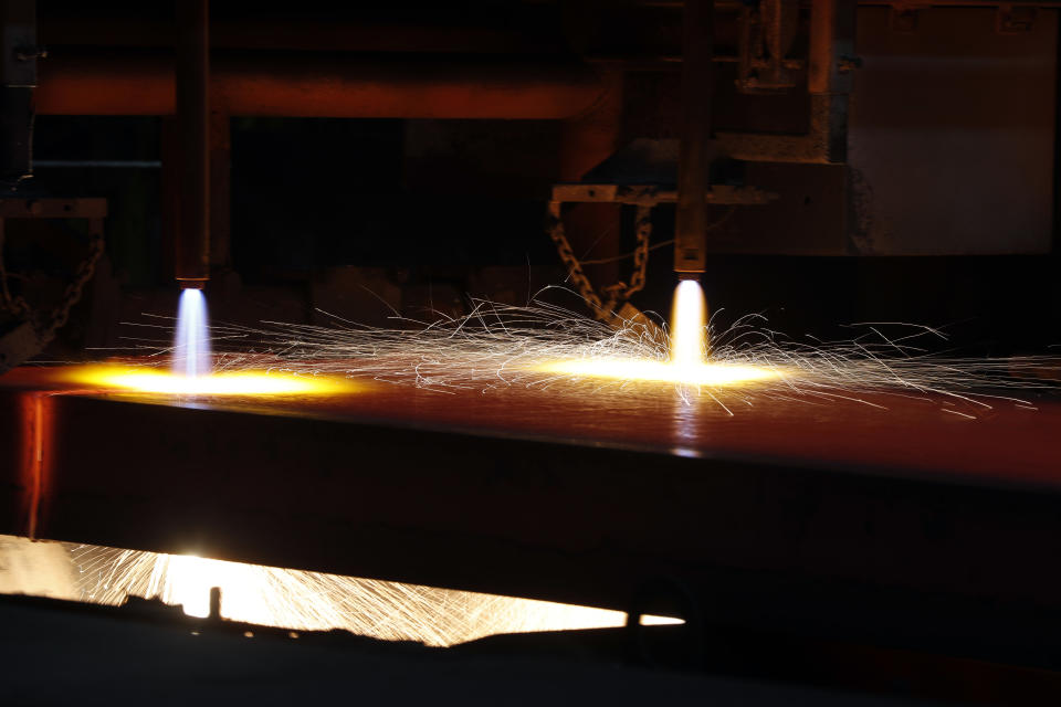 FILE - In this June 28, 2018, file photo a hot slab of steel is cut into sections after exiting the caster inside the U.S. Steel Granite City Works facility in Granite City, Ill. President Donald Trump’s decision last year to tax imported steel tested the limits of his legal authority, strained relations with key U.S. allies and imposed higher costs and uncertainty on much of American industry. But his 25% tariffs haven’t even done much for the companies they were supposed to help. (AP Photo/Jeff Roberson, File)