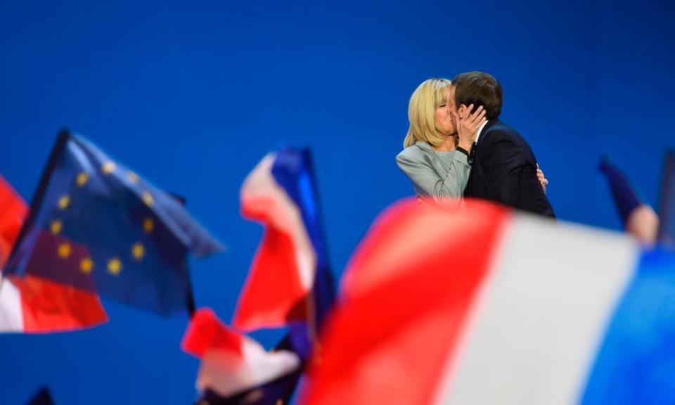 Emmanuel and Brigitte Macron embrace after the results of the first-round vote are announced.