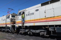 This Aug. 20, 2019, image shows train operator Ron Little preparing for one of the last trips to pick up coal from the Kayenta Mine to fuel the Navajo Generating Station near Page, Ariz. The power plant will close before the year ends, upending the lives of hundreds of mostly Native American workers who mined coal, loaded it and played a part in producing electricity that powered the American Southwest. (AP Photo/Felicia Fonseca)
