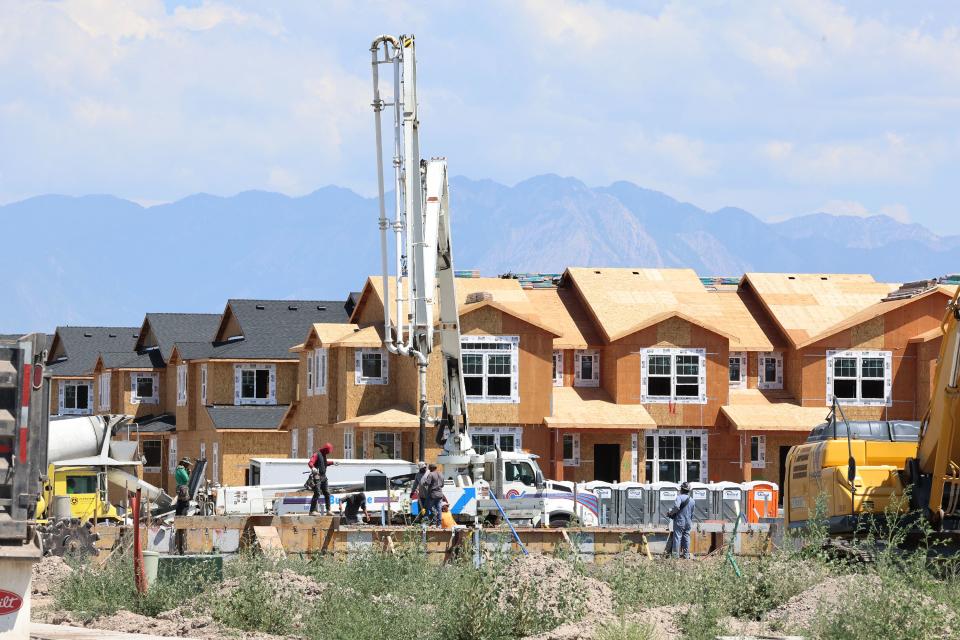 Workers pour concrete at the Ivory Homes Gabler’s Grove development in Magna on Tuesday, July 25, 2023. | Scott G Winterton, Deseret News