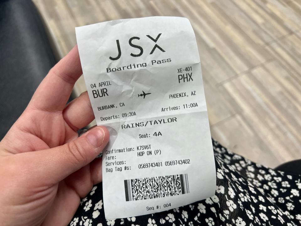 The author holding her boarding pass for her flight from Burbank, California, to Phoenix.