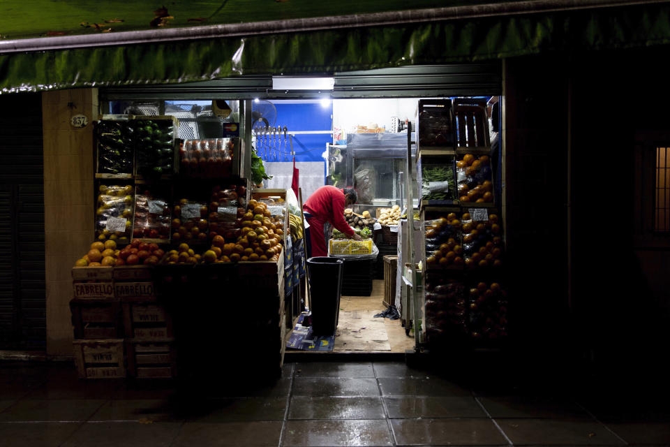 A vendor readies his shop in the Chacarita neighborhood in Buenos Aires, Argentina, early Monday morning, June 17, 2019. As lights turned back on across Argentina, Uruguay and Paraguay after a massive blackout that hit tens of millions people, authorities were still largely in the dark about what caused the collapse of the interconnected grid and were tallying the damage from the unforeseen disaster. (AP Photo/Tomas F. Cuesta)