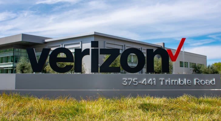 a Verizon (VZ) sign in front of headquarters building with grass in front