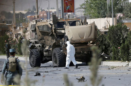 An Afghan official investigates a damaged Danish convoy at the site of a car bomb attack in Kabul, Afghanistan September 24, 2017. REUTERS/Omar Sobhani