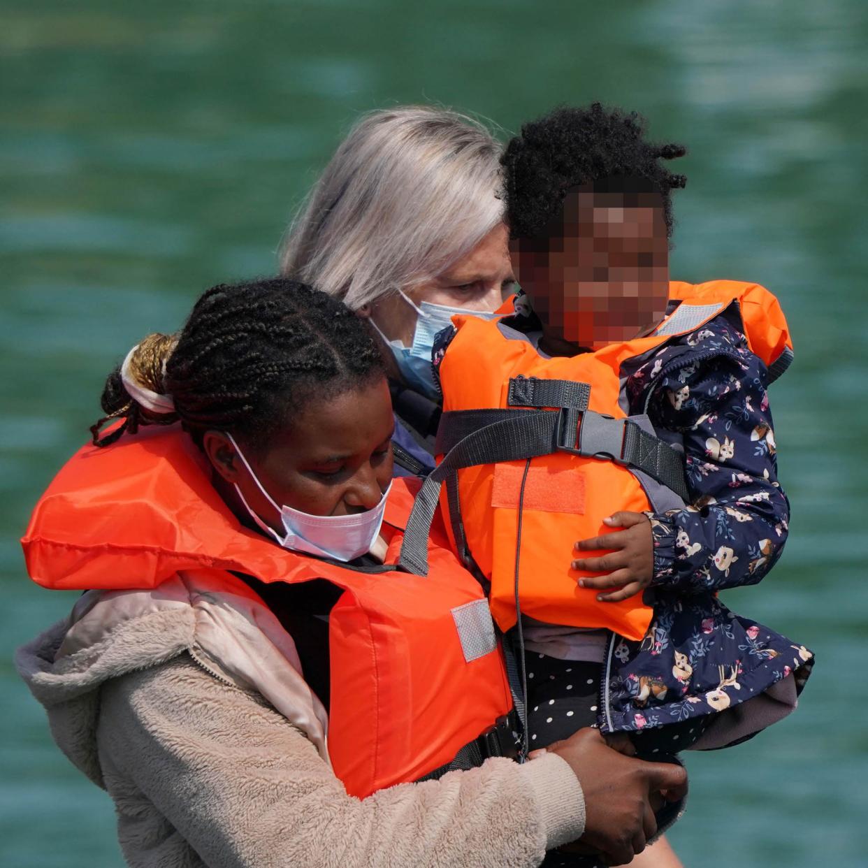 A group of people thought to be migrants are brought in to Dover, Kent, by Border Force officers following a small boat incident in the Channel (Gareth Fuller/PA)