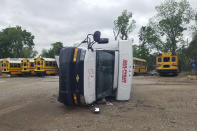 A school bus lies on its side after being knocked over during a tornado in Sulphur, Okla., Sunday, April 28, 2024. (AP Photo/Ken Miller)