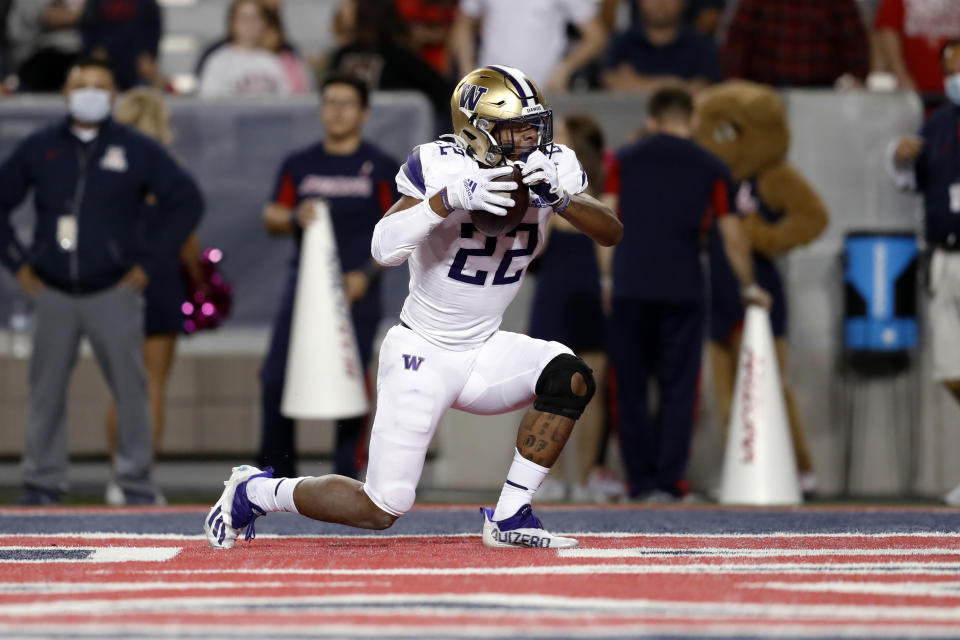 Washington running back Cameron Davis (22) reacts after scoring a touchdown during the second half of the team's NCAA college football game against Arizona on Friday, Oct. 22, 2021, in Tucson, Ariz. (AP Photo/Chris Coduto)