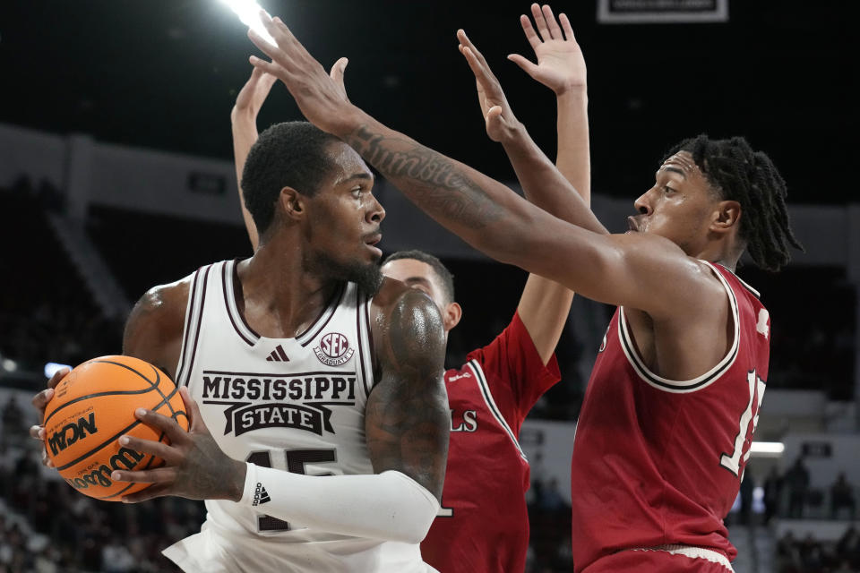 Mississippi State forward Jimmy Bell Jr. (15) looks for open man while Nicholls State forward Jamal West Jr. (15) challenges during the first half of an NCAA college basketball game in Starkville, Miss., Friday, Nov. 24, 2023. (AP Photo/Rogelio V. Solis)