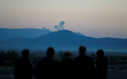 Smoke rises from the Syria's Afrin region, as it is pictured from near the Turkish town of Hassa, on the Turkish-Syrian border in Hatay province - Credit: Osman Orsal/Reuters