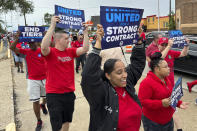 File - United Auto Workers members march at a union rally held near a Stellantis factory Wednesday, Aug. 23, 2023, in Detroit. Labor Day is right around the corner. And while many may associate the holiday with major retail sales and end-of summer barbecues, Labor Day's roots in worker-driven organizing feel especially significant this year. (AP Photo/Mike Householder, File)