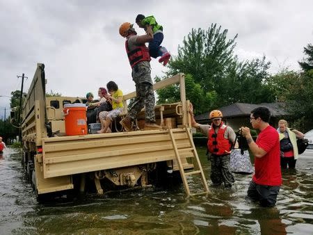 Texas National Guard soldiers aid residents in heavily flooded areas from the storms of Hurricane Harvey in Houston, Texas, U.S., August 27, 2017 Lt. Zachary West, 100th MPAD/Texas Military Department/Handout via REUTERS