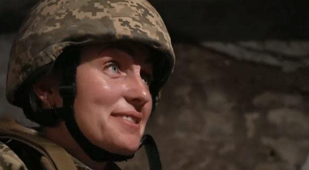 Oksana Kozyrenko, a Ukrainian soldier and head of a local civil-military cooperation group near the Russian-occupied southern city of Kherson, speaks to CBS News in a shelter during Russian shelling of a village near Kherson, in late May, 2022. / Credit: CBS News