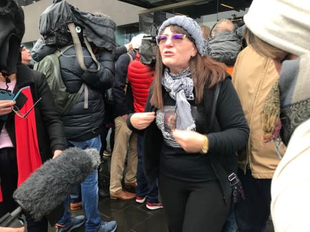 FILE PHOTO: Janna Ezat, wearing a T-shirt in memorial of her son who was killed at Al Noor mosque on March 15, reacts outside the Christchurch High Court after accused gunman Brenton Tarrant pleaded not guilty to all charges, New Zealand