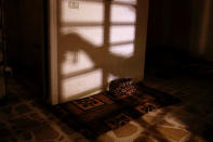 <p>The shadow of a member of the Iraqi Army’s 9th Armoured Division is seen as he opens a steel gate to a room used as a cell for men, inside a compound used as a prison by Islamic State militants in the 17 Tamuz (July 17) district, in western Mosul, Iraq, June 6, 2017. (Alkis Konstantinidis/Reuters) </p>