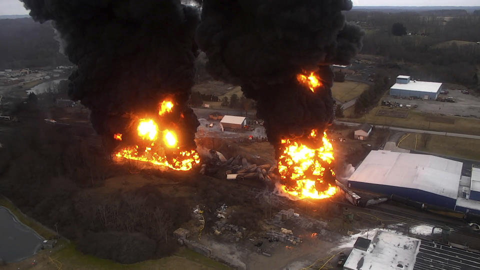 A frame grab from drone video taken by the Columbiana County Commissioner’s Office and released by the NTSB shows towering flames and columns of smoke resulting from a "vent and burn" operation following the train derailment in East Palestine, Ohio, on Feb. 6, 2023. Residents of eastern Ohio can now get an up-close view in newly released videos of the twin toxic towers of fire that forced them from their homes last February when officials decided to blow open five tank cars filled with vinyl chloride they worried might explode days after a Norfolk Southern train derailed. (Columbiana County Commissioner’s Office/NTSB via AP)