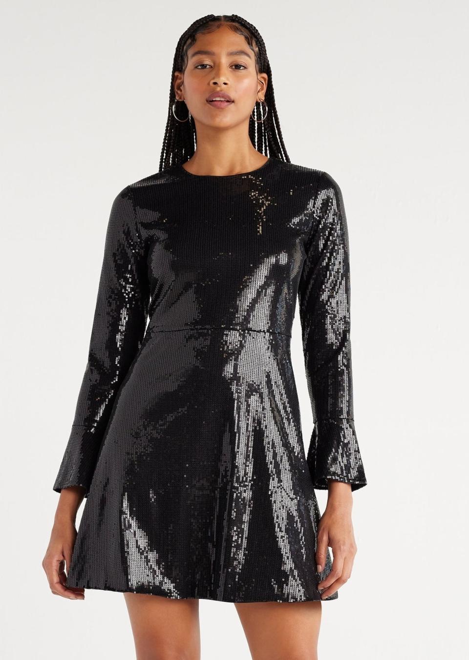 model wearing the black sequin dress