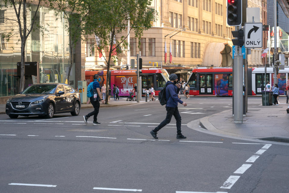 People crossing road at traffic lights. Source: Getty Images