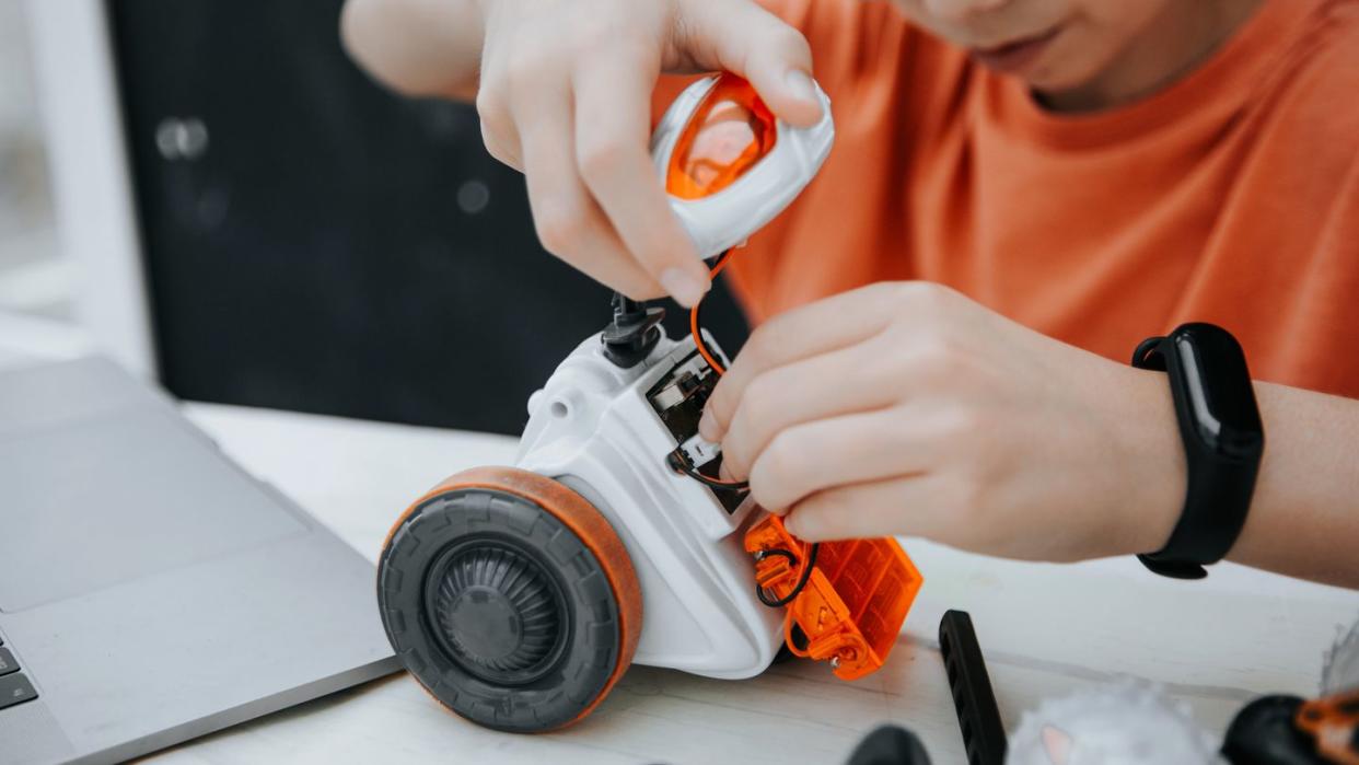 boy playing with robot toy