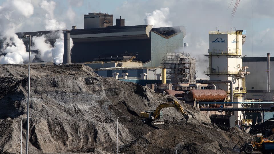 An excavator on a stockpile of coal at the Tata Steel plant in Wijk aan Zee, the Netherlands, on Wednesday, March 15, 2023. - Peter Boer/Bloomberg/Getty Images