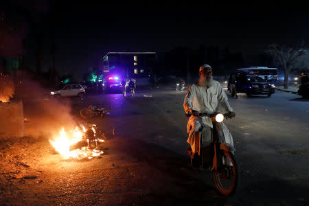 A man rides a motorbike during a protest, after paramilitary and police forces disperse the supporters of the Tehrik-e-Labaik Pakistan Islamist political party, in Karachi, Pakistan November 24, 2018. REUTERS/Akhtar Soomro